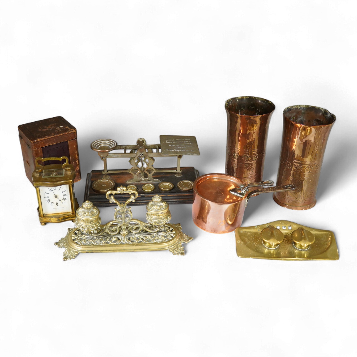 A collection of items to include a leather cased gilt brass French carriage clock, a German bronze Jugendstil inkwell, a late 19th century ink brass inkwell, a set of postal scales with weights, a Temple & Crook small co